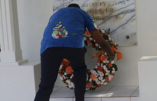 Premier Dr Natalio Wheatley lays the wreath at the tombstone of former Chief Minister H Lavity Stoutt. (Photos by Andre 'Shadow' Dawson/BVI News photographer)